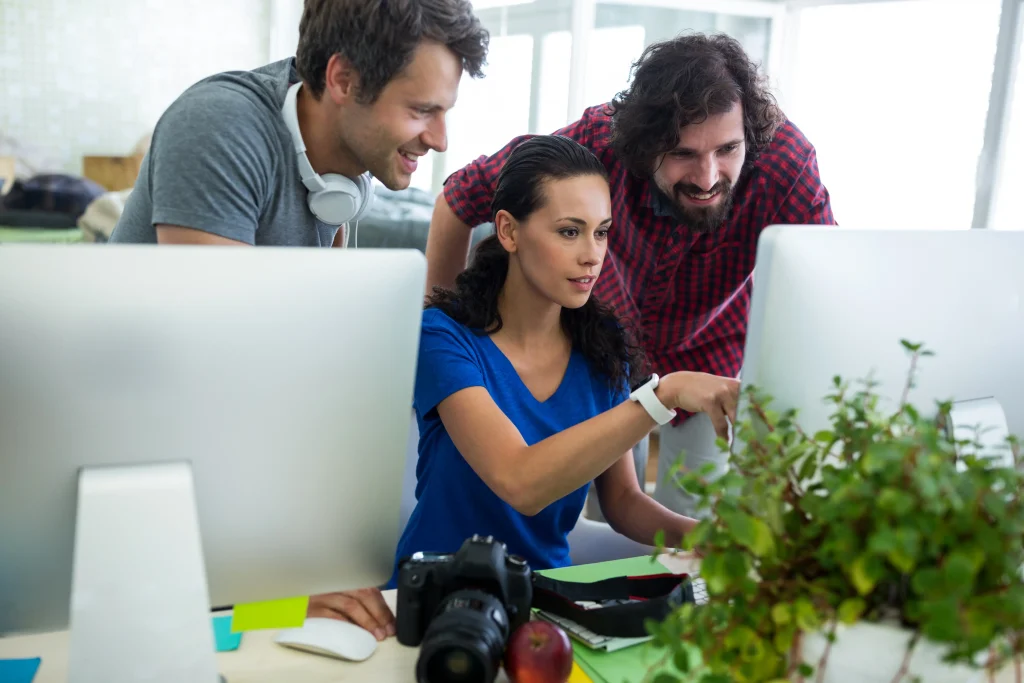 group graphic designers interacting computer